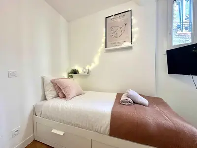 Un ou plusieurs lits dans un hébergement de l'établissement New 438 Suite Jean - Cosy Apartment Paris Center