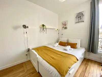 Un ou plusieurs lits dans un hébergement de l'établissement New 447 Suite Welles - Cosy Apartment Paris Center