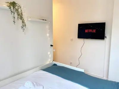 Un ou plusieurs lits dans un hébergement de l'établissement New 452 Suite Newman - Cosy Apartment Paris Center