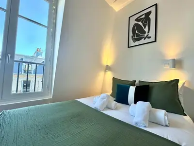 Un ou plusieurs lits dans un hébergement de l'établissement New 463 Suite Macnee - Cosy Apartment Paris Center