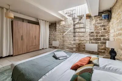Un ou plusieurs lits dans un hébergement de l'établissement Appartement familial proche des commerces - 8P