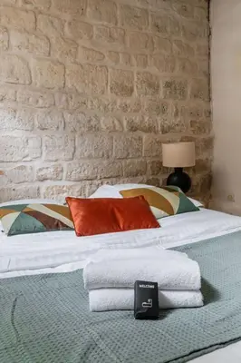Un ou plusieurs lits dans un hébergement de l'établissement Appartement familial proche des commerces - 8P
