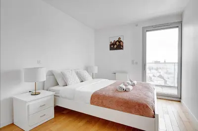 Un ou plusieurs lits dans un hébergement de l'établissement Suite Mitterand, Penthouse Parisien avec balcon
