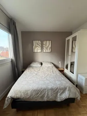 Un ou plusieurs lits dans un hébergement de l'établissement Courbevoie Apartment - HBA
