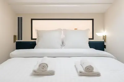 Un ou plusieurs lits dans un hébergement de l'établissement Stylish Duplex for 4 in Bastille Paris