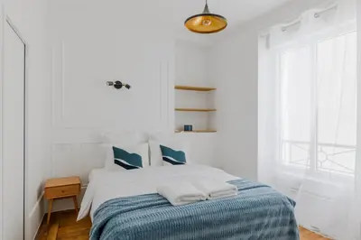 Un ou plusieurs lits dans un hébergement de l'établissement Paris Center Colisée residence
