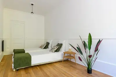 Un ou plusieurs lits dans un hébergement de l'établissement Paris Center Colisée residence