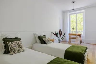 Un ou plusieurs lits dans un hébergement de l'établissement Paris Center Colisée residence