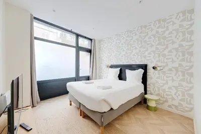Un ou plusieurs lits dans un hébergement de l'établissement Central Apartement 6p L004