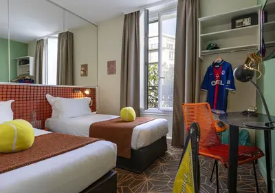 Un ou plusieurs lits dans un hébergement de l'établissement Hotel Olympic Paris Boulogne by Patrick Hayat