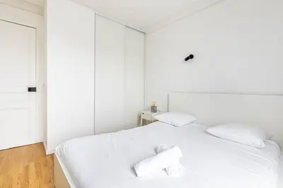 Un ou plusieurs lits dans un hébergement de l'établissement GuestReady - Cosy flat near Arc de Triomphe
