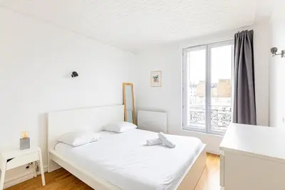 Un ou plusieurs lits dans un hébergement de l'établissement GuestReady - Cosy flat near Arc de Triomphe