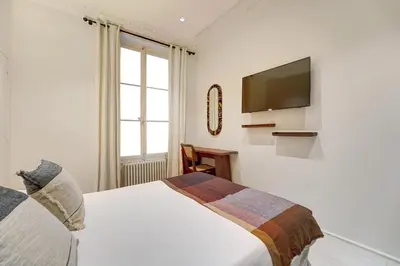 Un ou plusieurs lits dans un hébergement de l'établissement NoChichi Collections - Grand Rex