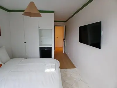 Un ou plusieurs lits dans un hébergement de l'établissement Grand 5 Chambres Paris La Defense