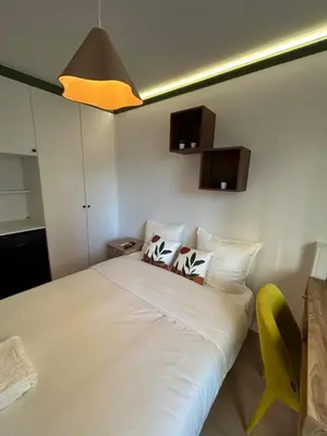 Un ou plusieurs lits dans un hébergement de l'établissement Grand 5 Chambres Paris La Defense