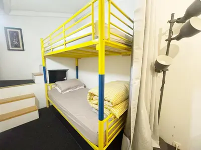Un ou plusieurs lits dans un hébergement de l'établissement Cozy House Notre-Dame