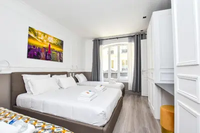 Un ou plusieurs lits dans un hébergement de l'établissement Cosy appt - Grands boulevards Musee Grevin