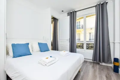 Un ou plusieurs lits dans un hébergement de l'établissement Cosy appt - Grands boulevards Musee Grevin