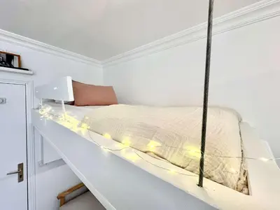 Un ou plusieurs lits dans un hébergement de l'établissement New 143 Suite La Rochelle - Cosy Apartment Paris Center