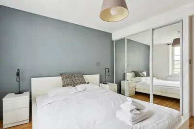 Un ou plusieurs lits dans un hébergement de l'établissement BnBNova - 2BR - Les Halles & Le Marais