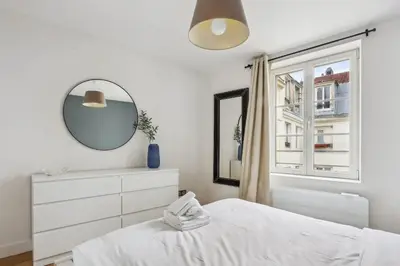 Un ou plusieurs lits dans un hébergement de l'établissement BnBNova - 2BR - Les Halles & Le Marais