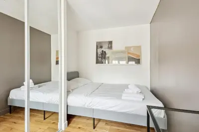Un ou plusieurs lits dans un hébergement de l'établissement BnBNova - 2BR - Les Halles & Le Marais