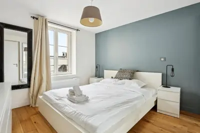 Un ou plusieurs lits dans un hébergement de l'établissement BnBNova - 2BR - Les Halles & Le Marais