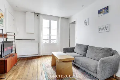 Coin salon dans l'établissement BM-Nid Cosy a Oberkampf - pour Deux