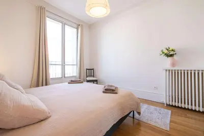 Un ou plusieurs lits dans un hébergement de l'établissement Eiffel Tower View 3BR Balcony