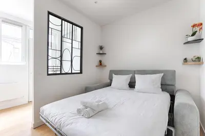 Un ou plusieurs lits dans un hébergement de l'établissement Cosy Studio Cité Pilleux