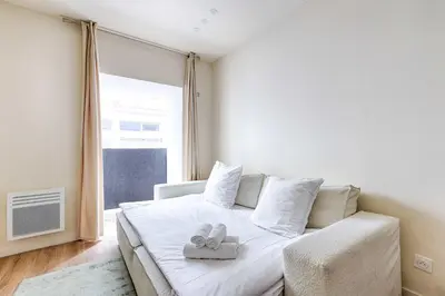 Un ou plusieurs lits dans un hébergement de l'établissement Appartement de charme au coeur d'Alesia