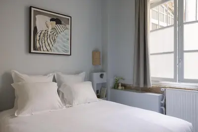 Un ou plusieurs lits dans un hébergement de l'établissement Notre Dame Paris Suite