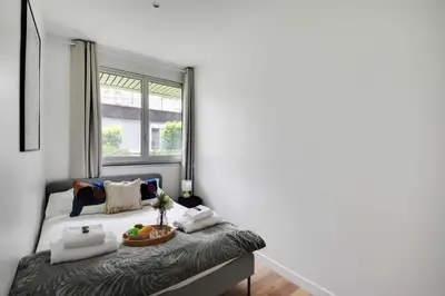 Un ou plusieurs lits dans un hébergement de l'établissement Magnifique Appartement 3BR 8P Nation