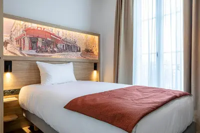 Un ou plusieurs lits dans un hébergement de l'établissement Dantan Hôtel
