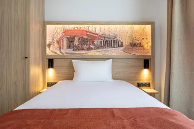 Un ou plusieurs lits dans un hébergement de l'établissement Dantan Hôtel