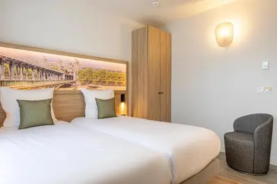 Un ou plusieurs lits dans un hébergement de l'établissement Dantan Hôtel