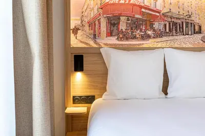 Un ou plusieurs lits dans un hébergement de l'établissement Dantan Hôtel