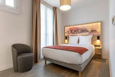 Un ou plusieurs lits dans un hébergement de l'établissement Dantan Hôtel