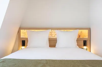 Un ou plusieurs lits dans un hébergement de l'établissement Dantan Hôtel