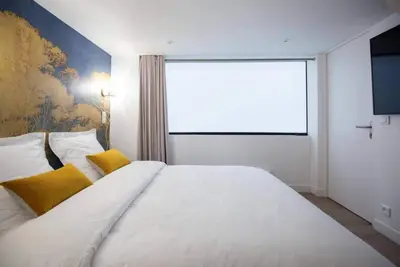 Un ou plusieurs lits dans un hébergement de l'établissement Lemoine Reaumur 2 Cosy Appartement 6P 2BR