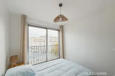 Un ou plusieurs lits dans un hébergement de l'établissement Spacious T7 in Paris 20