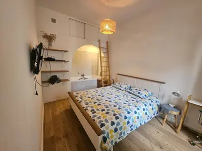 Un ou plusieurs lits dans un hébergement de l'établissement appartement aux portes de Paris