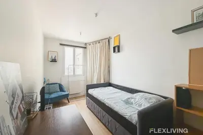 Un ou plusieurs lits dans un hébergement de l'établissement Mignon studio dans Paris 18ème