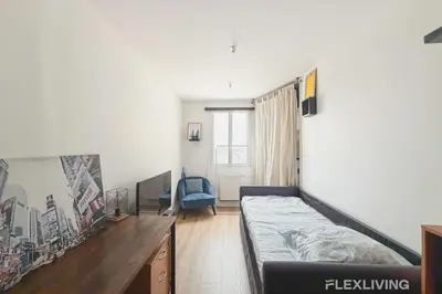 Un ou plusieurs lits dans un hébergement de l'établissement Mignon studio dans Paris 18ème