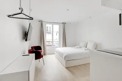 Un ou plusieurs lits dans un hébergement de l'établissement Studio cosy & élégant au cœur de Paris