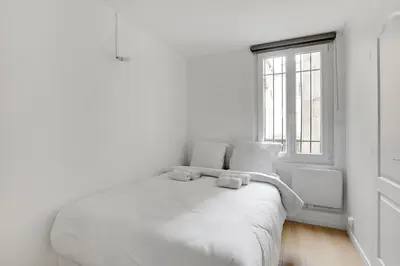 Un ou plusieurs lits dans un hébergement de l'établissement Appartement cosy & central au cœur de Paris