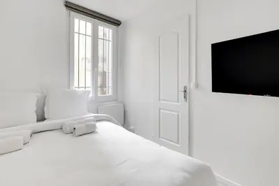 Un ou plusieurs lits dans un hébergement de l'établissement Appartement cosy & central au cœur de Paris