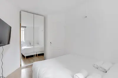 Un ou plusieurs lits dans un hébergement de l'établissement Appartement cosy & central au cœur de Paris