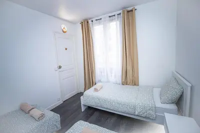Un ou plusieurs lits dans un hébergement de l'établissement Chambre salon pont de l ourcq