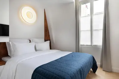Un ou plusieurs lits dans un hébergement de l'établissement Louvre élégance appartements de charme